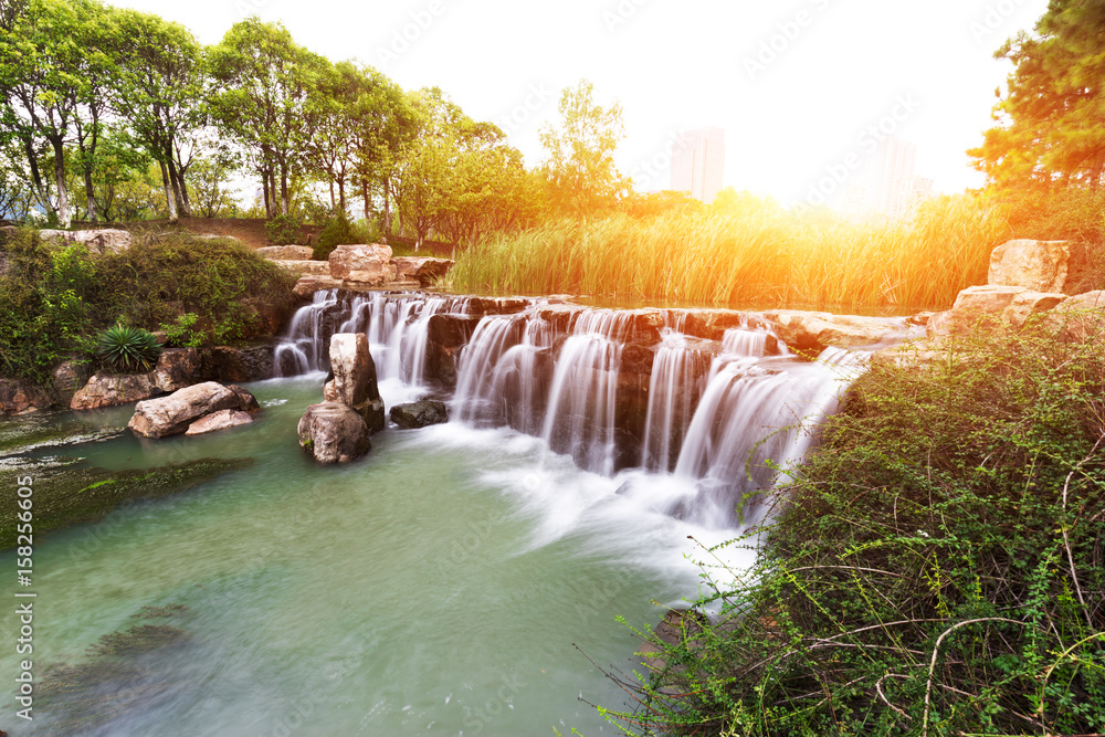 beautiful waterfall with sunbeam