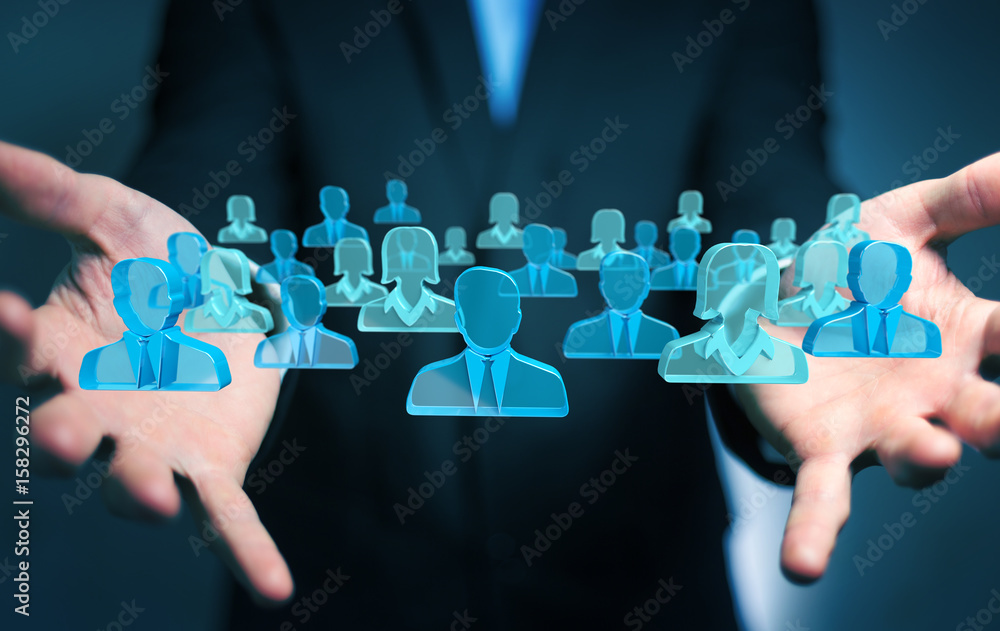 Businessman holding 3D rendering group of blue people