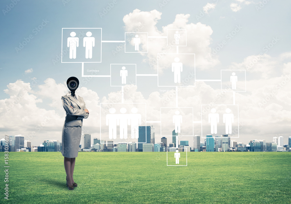 Camera headed woman standing on green grass against modern citys