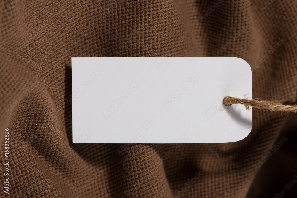 Shirt price tag. Rectangular tag is attached to a sweater