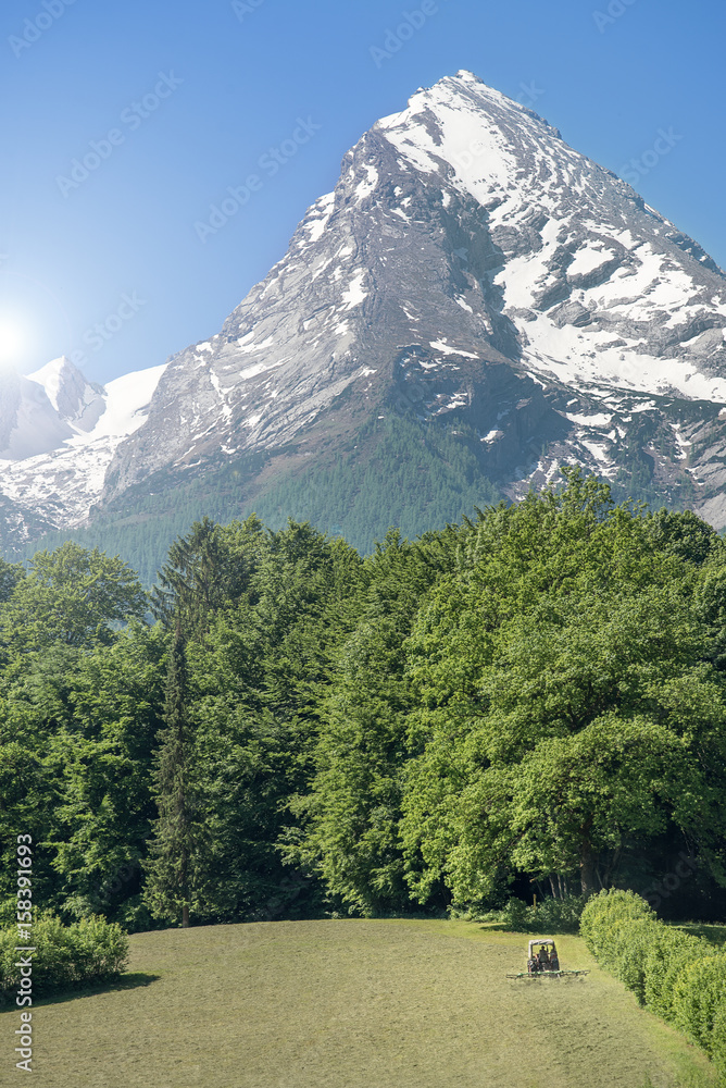 Tractor in front of the imposing Watzmann, Bavaria, Germany