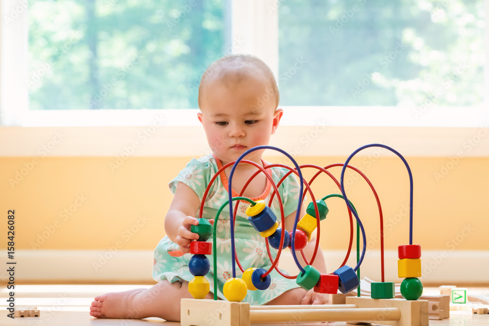 Toddler girl playing in her house