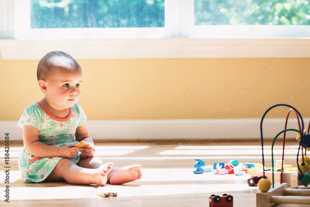 Toddler girl playing in her house