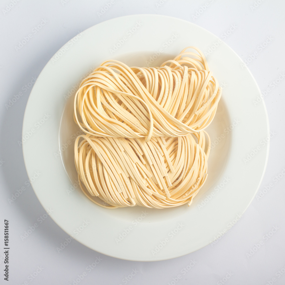 Fresh tagliatelle pasta into a plate