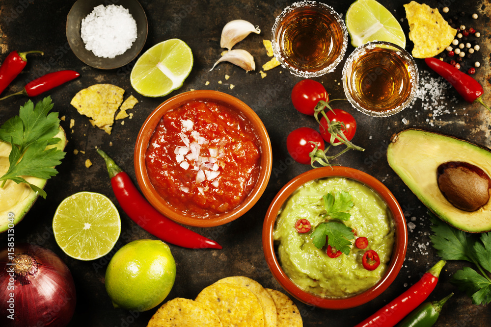 Green Homemade Guacamole with Tortilla Chips, Salsa and tequila shots