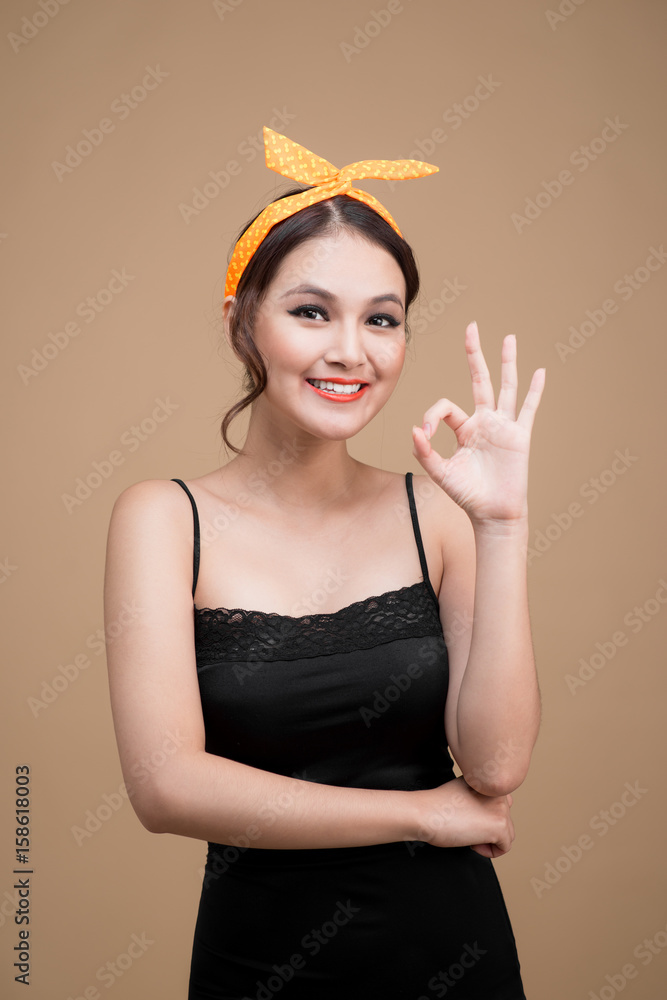 Beautiful woman pinup style portrait. Asian woman hands gesture