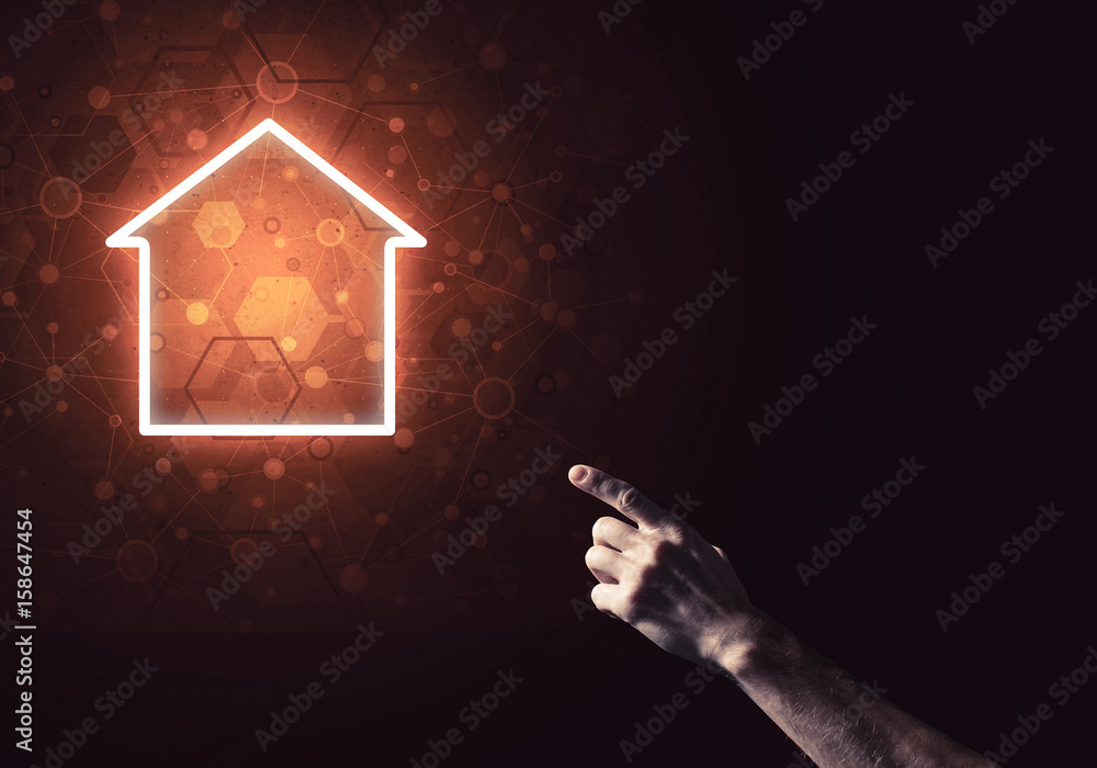 Conceptual image with hand pointing at house or main page icon o