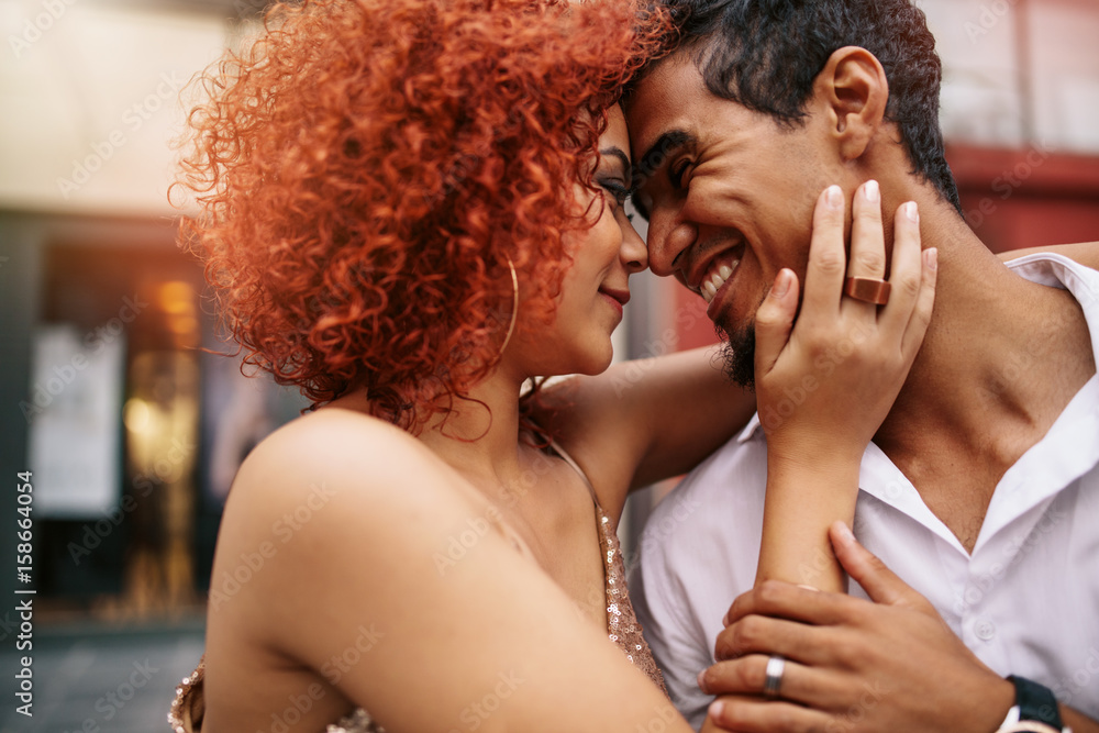 Young couple in a romantic mood out in the street.