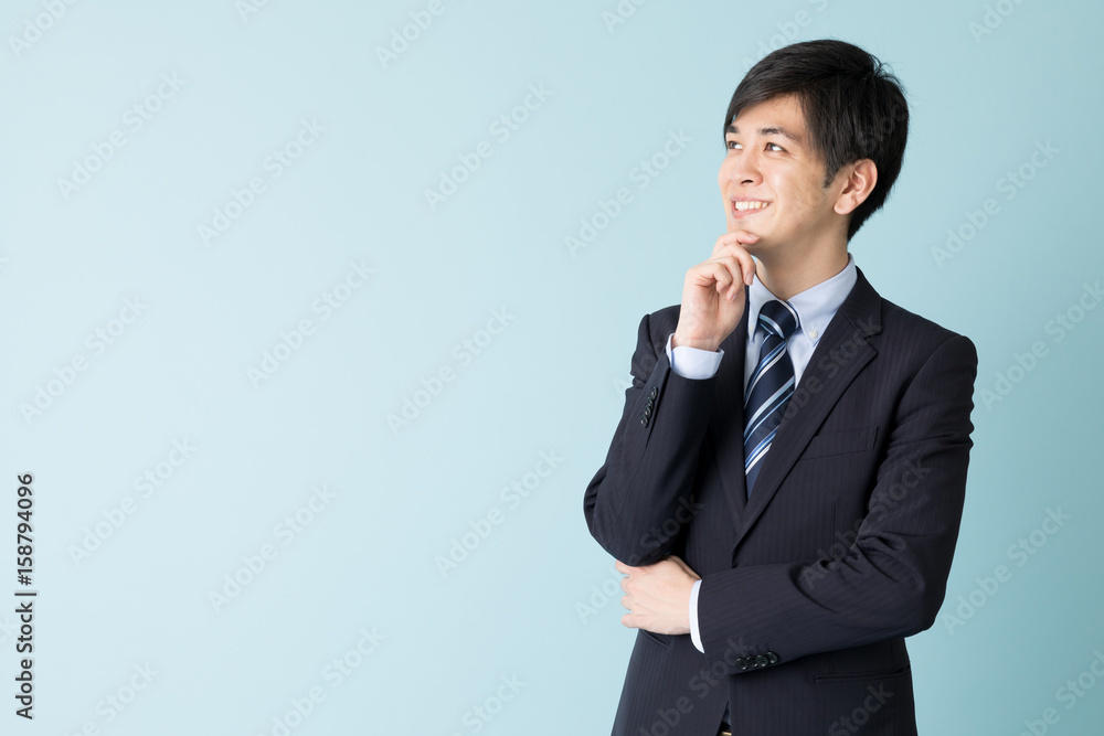 portrait of asian businessman isolated on blue background