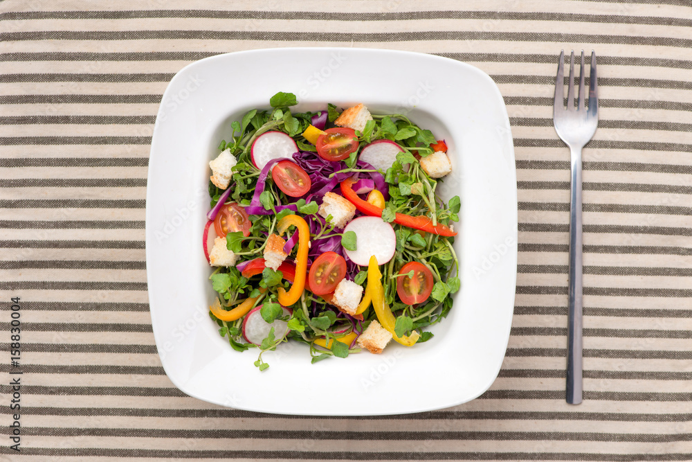 Homemade fresh green vegetable salad on table.