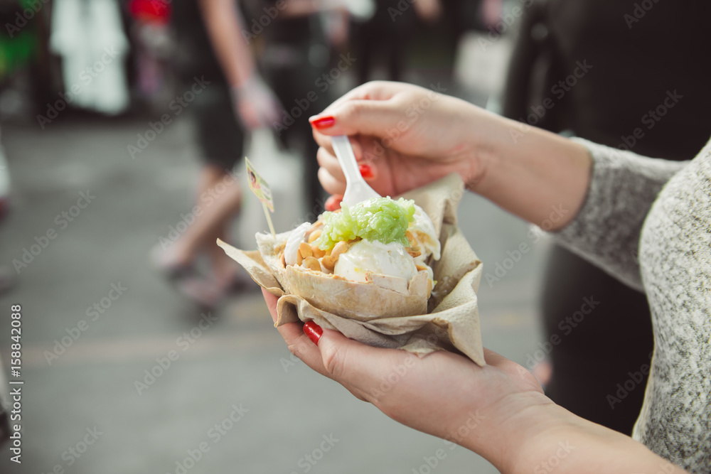 Woman hands holding ice cream on coconut