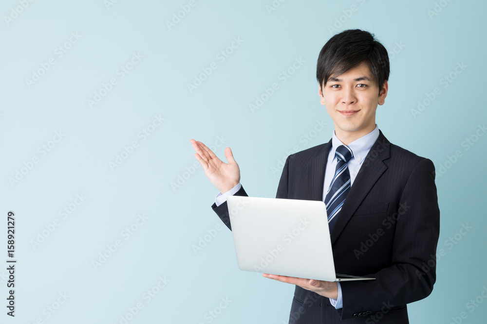 portrait of asian businessman isolated on blue background