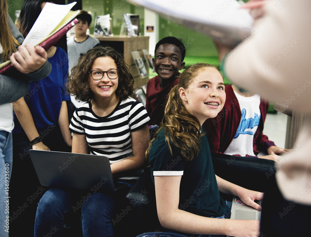 Group of students learning in classroom