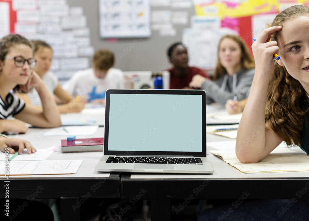 Group of students learning in classroom