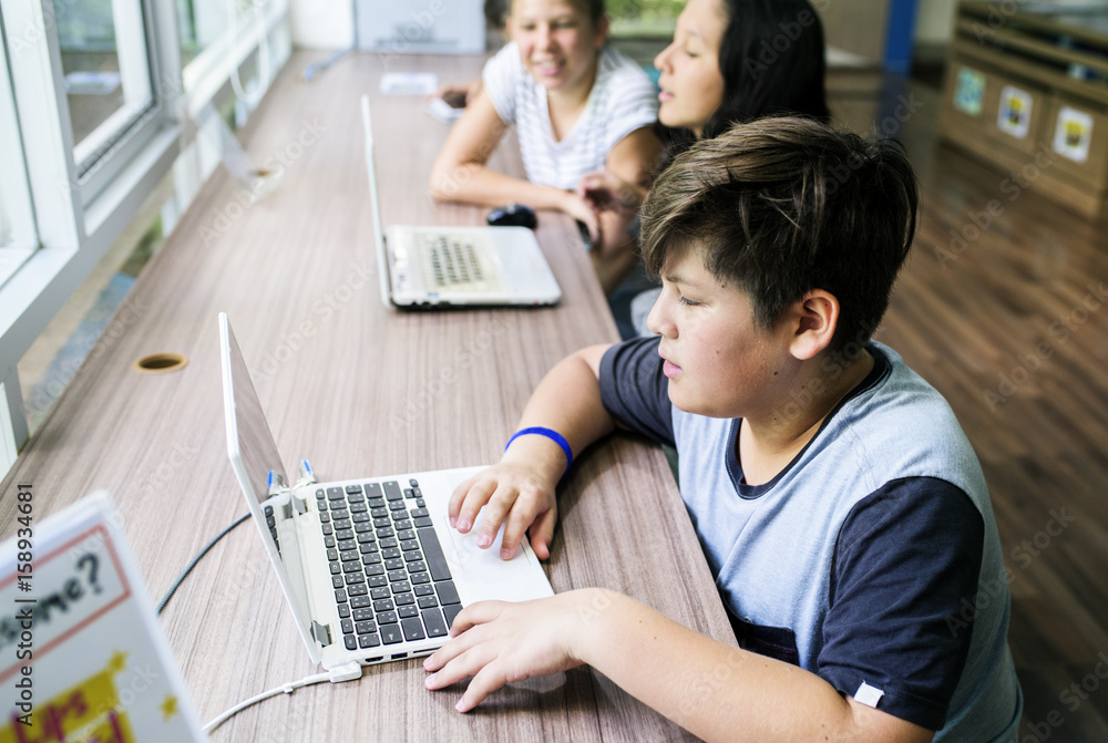 Group of students using laptop