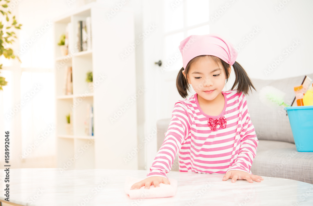 happy little girl learning cleaning