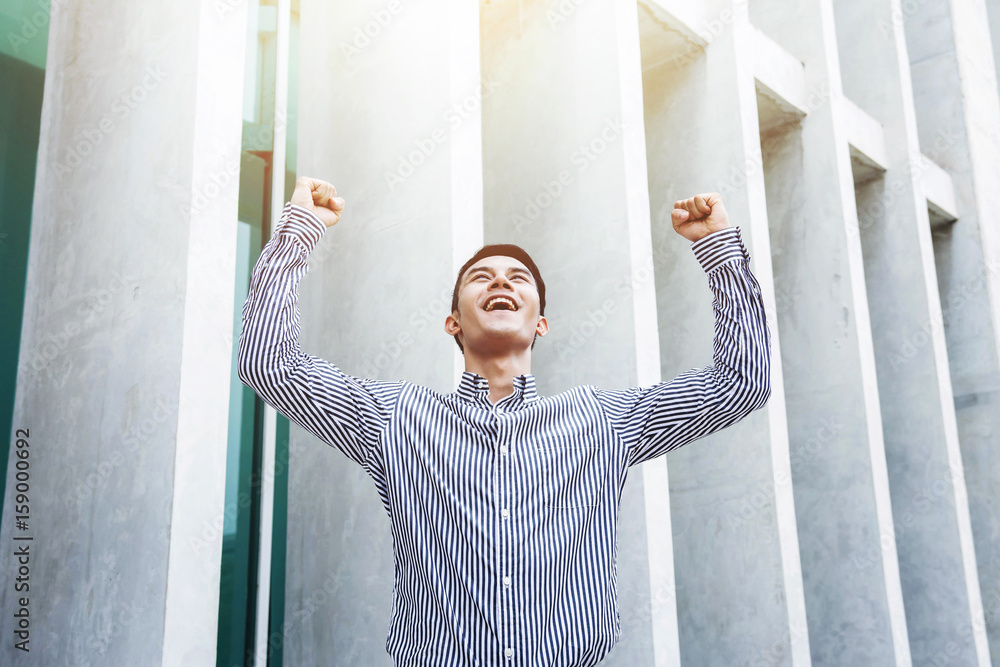 Happy excited Young and modern Businessman celebrate in cheerful posture outside office building, Su