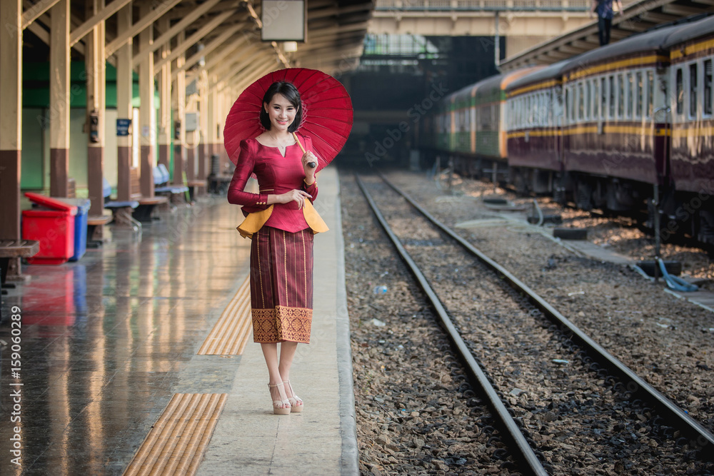 Beautiful Thai girl in Thai costume,Asian woman wearing traditional Thai culture at train station,Ba