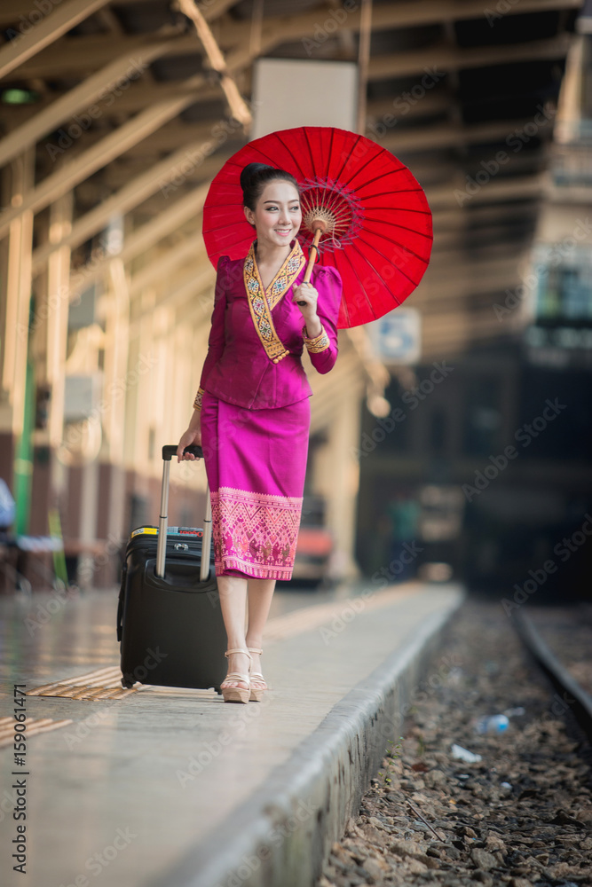 Beautiful Thai girl in Thai costume,Asian woman wearing traditional Thai culture at train station,Ba