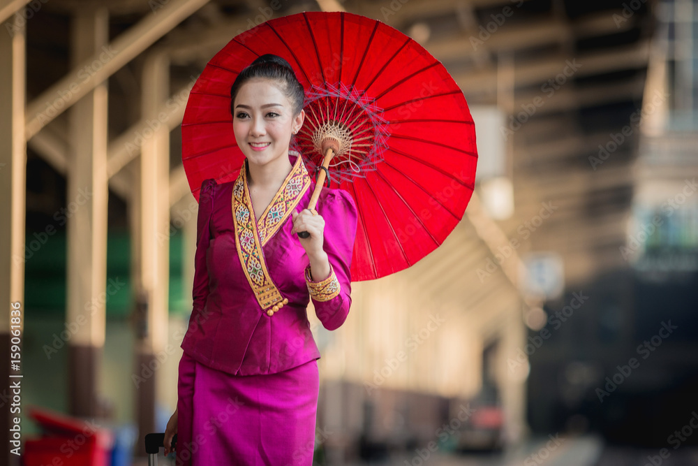 Beautiful Thai girl in Thai costume,Asian woman wearing traditional Thai culture at train station,Ba