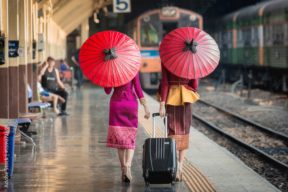 Beautiful Thai girl in Thai costume,Asian woman wearing traditional Thai culture at train station,Ba