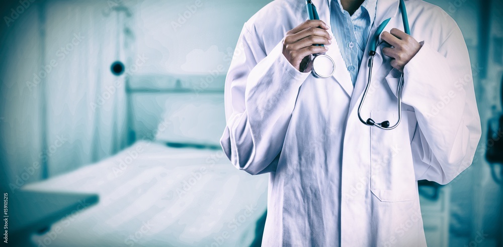 Composite image of asian doctor holding stethoscope