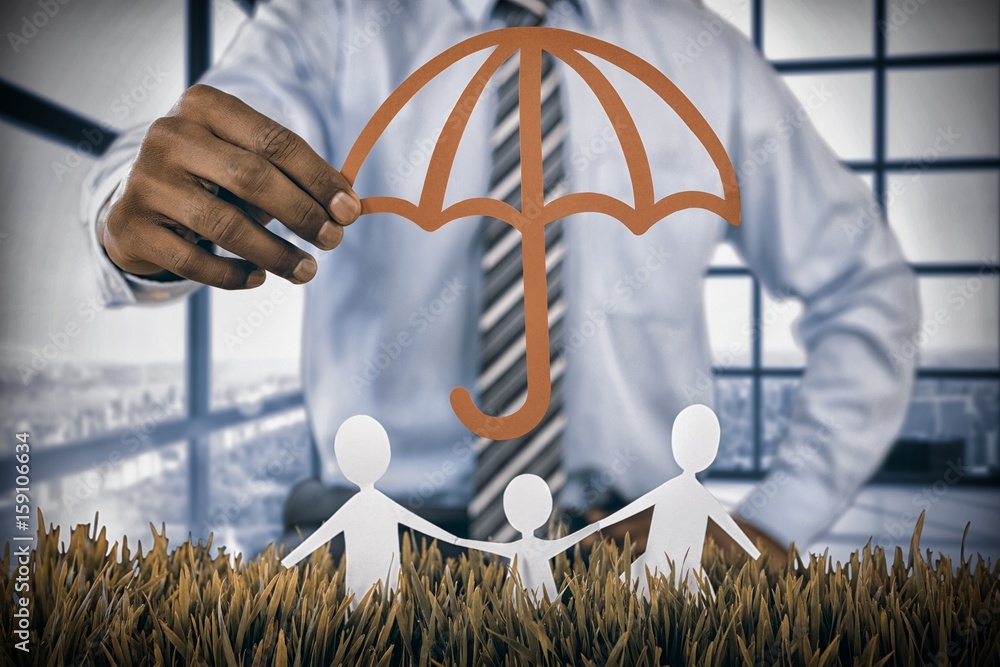 Composite image of family protected by a red umbrella