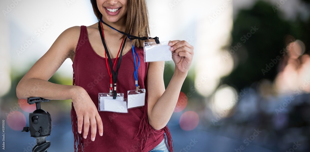 Composite image of portrait of happy woman holding identity card