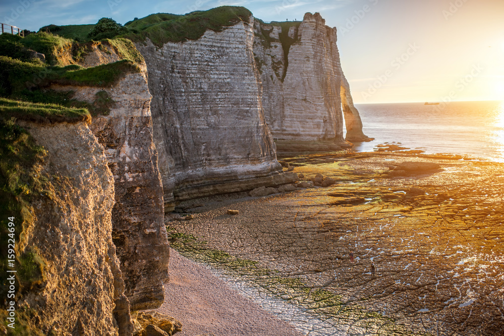 Landscape view on the rocky coastline near Etretat town in France during the sunset