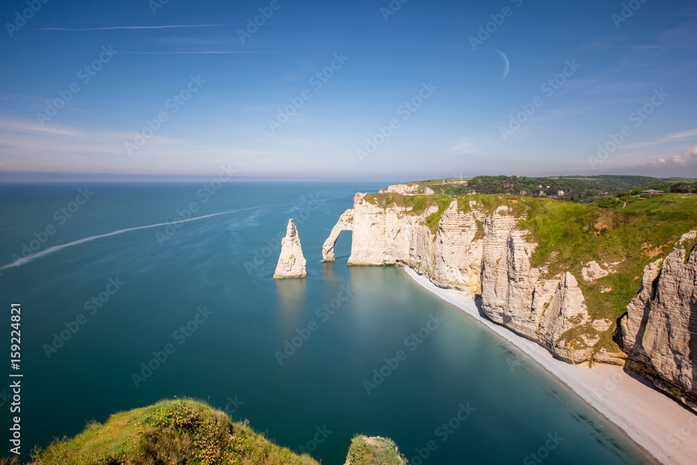 Landscape view on the famous rocky coastline near Etretat town in France during the sunny day. Long 