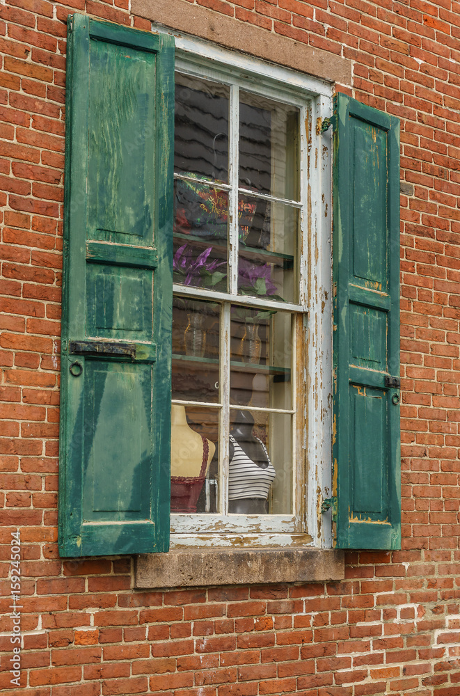 Old house red wall with green wooden window