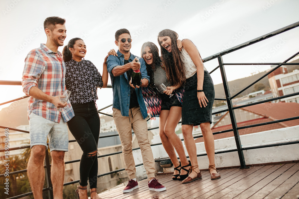 Young people having champagne at party.