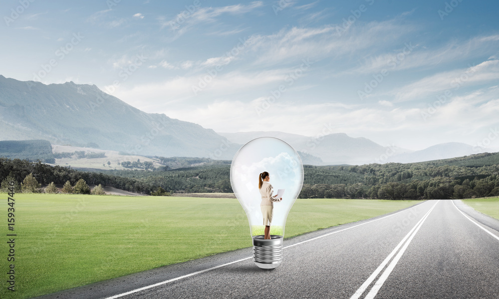 Businesswoman inside light bulb