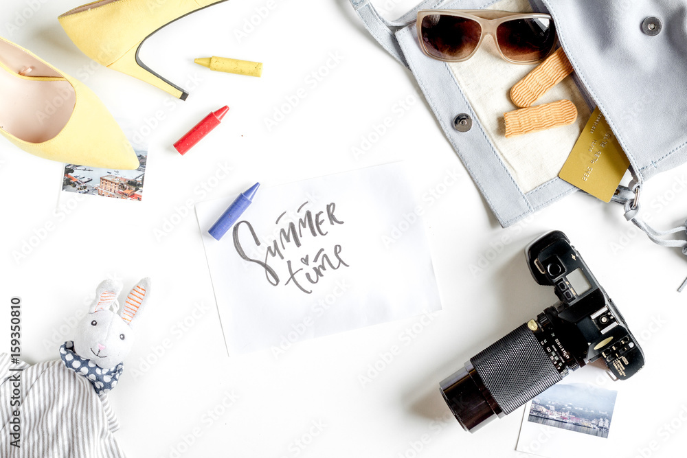 tourist equipment with toys and camera for traveling with kids on white background top view