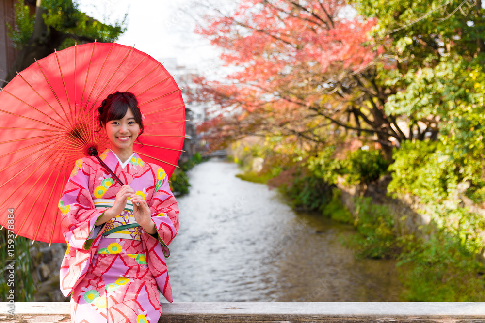 portrait of young asian woman waering kimono in autumn