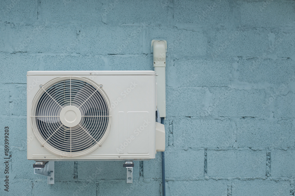 Condenser air conditioner with vintage brick background