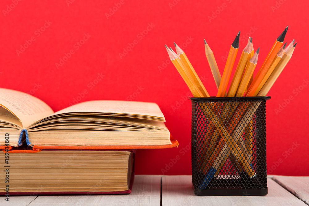 education and wisdom concept - open book on wooden table, color background