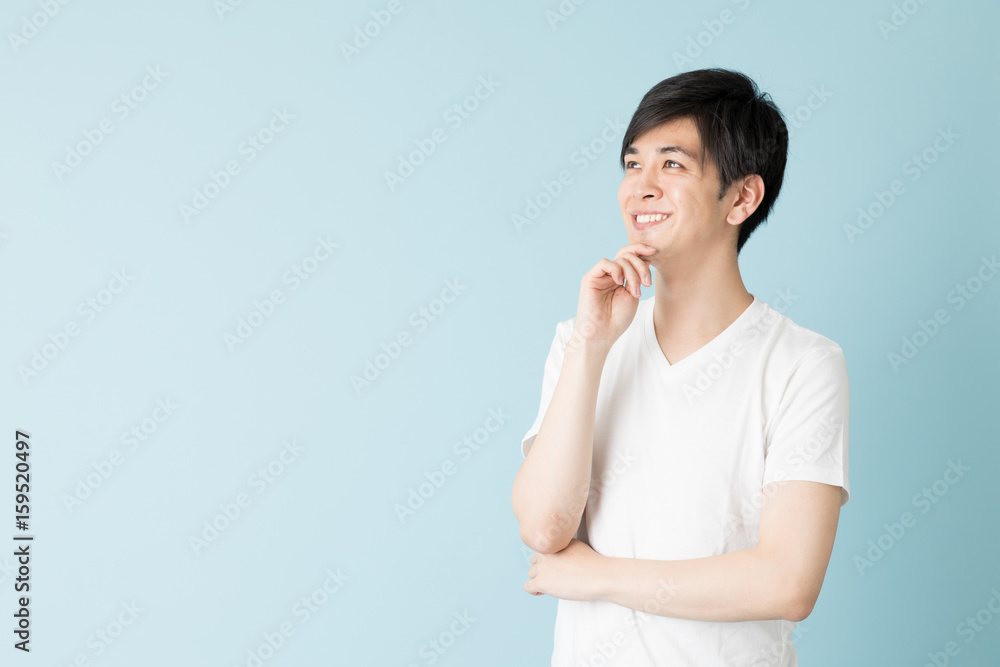 portrait of young asian man isolated on blue background