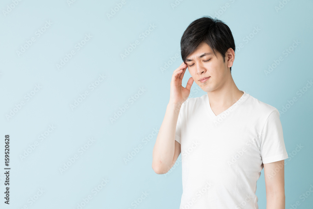 portrait of young asian man isolated on blue background