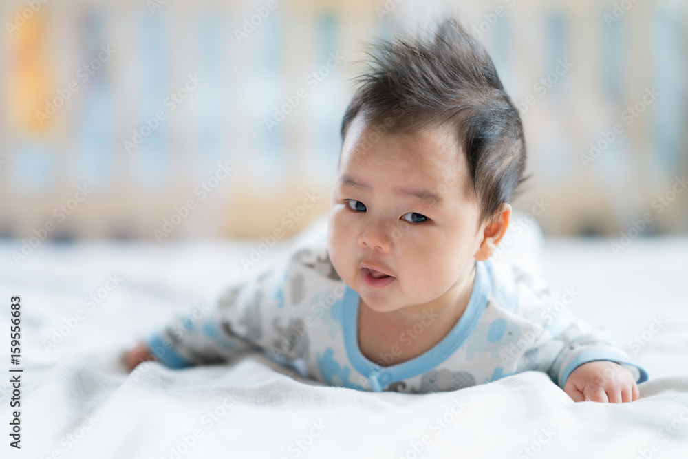 Newborn boy smile on the bed