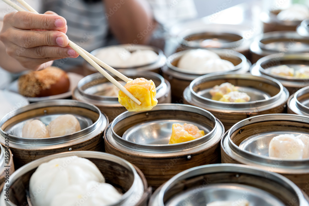 Chinese streamed dumpling in bamboo basket on table in Chinese restaurant.