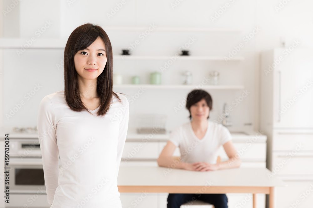 young asian couple relaxing in kitchen