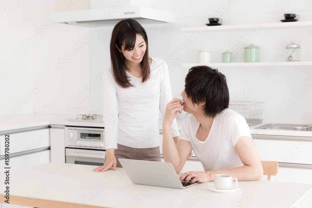 young asian couple relaxing in kitchen