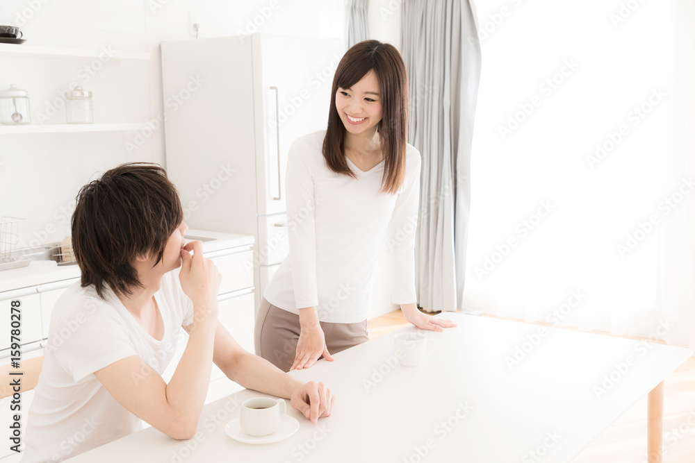 young asian couple relaxing in kitchen