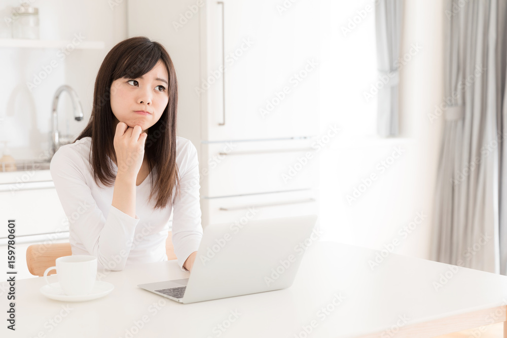 young asian woman relaxing in kitchen