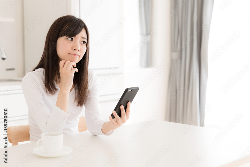 young asian woman relaxing in kitchen