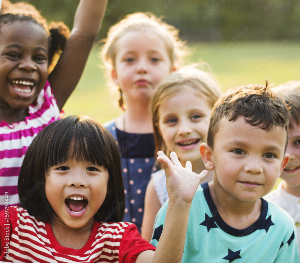 Group of kindergarten kids friends playing playground fun and smiling