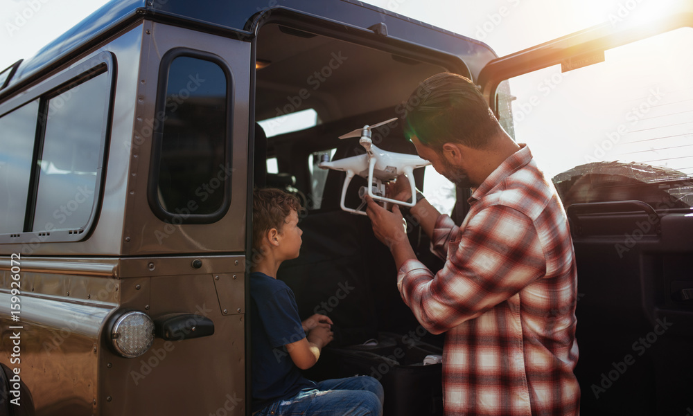 Father and son set up a drone to fly