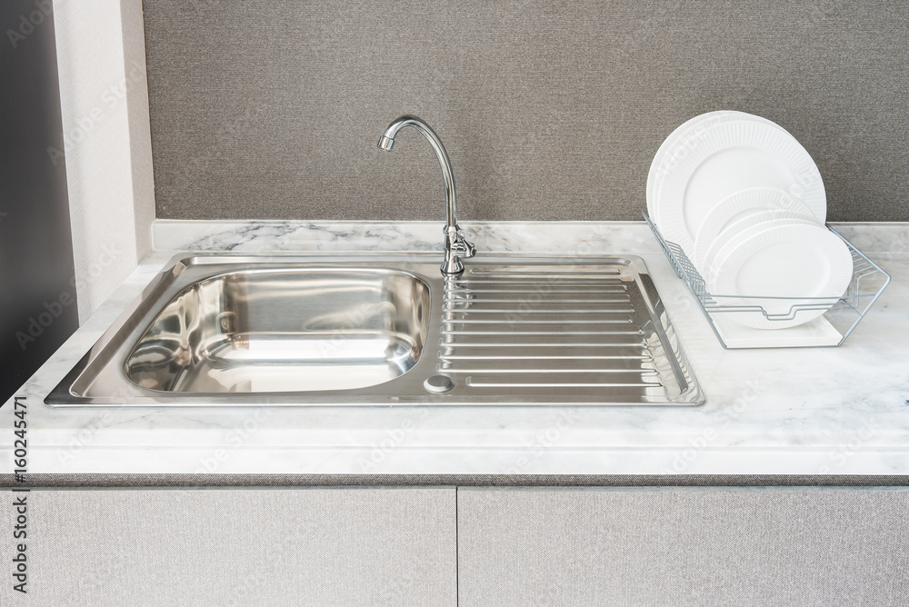 modern kitchen room with sink on granite counter top