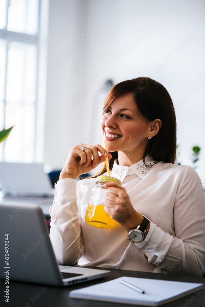 Businesswoman drinking summer sweet fruit juice